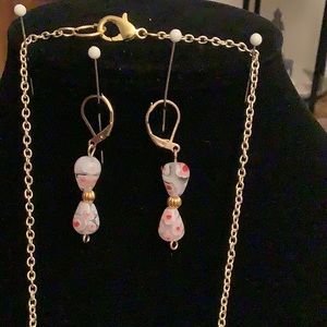 A Lamp work glass necklace and earrings.